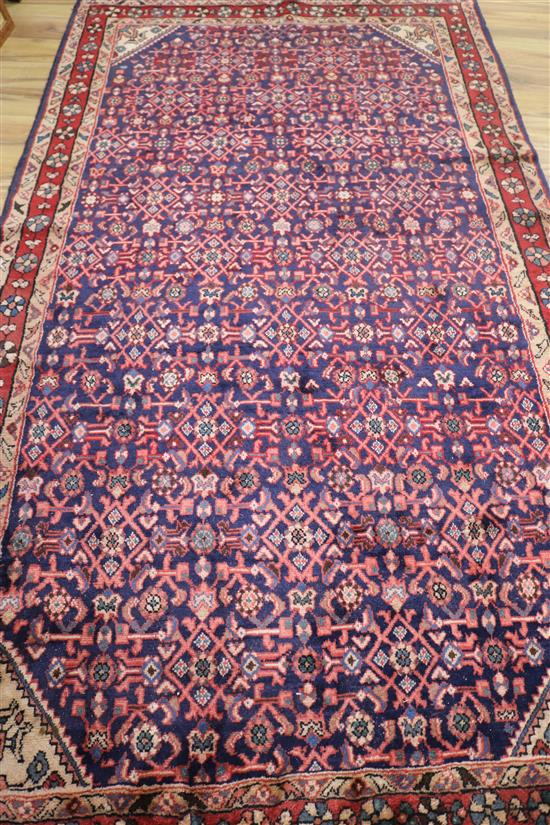 A Hamadan blue ground rug, 9ft 3in by 5ft 3in.